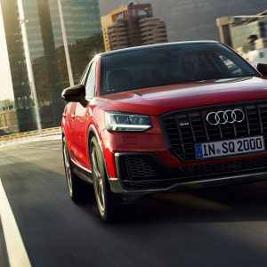 Audi Q2 e-Tron 2020 red color front on road in speed city background 4k widescreen cars wallpaper