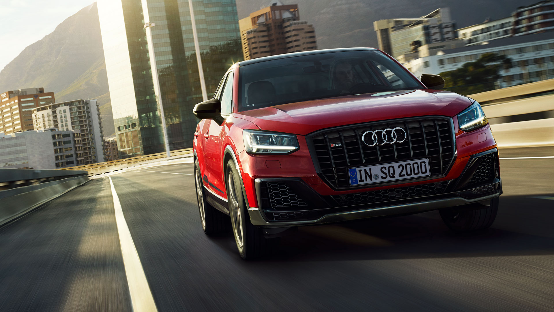 Audi Q2 e-Tron 2020 red color front on road in speed city background 4k widescreen cars wallpaper